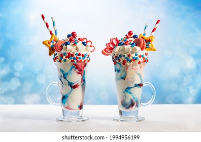 Crazy Milk Shake With Ice Cream,whipped Cream, Marshmallow,cookies And Colored Candy In Glass. Sweet Dessert For Fourth Of July. Idea Milkshake For Patriotic Day.