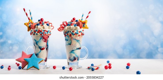 Crazy Milk Shake With Ice Cream,whipped Cream, Marshmallow,cookies And Colored Candy In Glass. Sweet Dessert For Fourth Of July. Idea Milkshake For Patriotic Day.