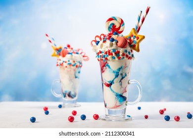 Crazy Milk Shake With Ice Cream,whipped Cream, Marshmallow,cookies And Colored Candy In Glass. Sweet Dessert For Fourth Of July. Idea Milkshake For Patriotic Day.