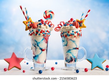 Crazy Milk Shake With Ice Cream,whipped Cream, Marshmallow,cookies And Colored Candy In Glass. Sweet Dessert For Fourth Of July. Idea Milkshake For Patriotic Day.