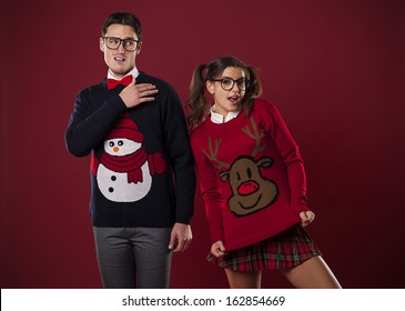 Crazy nerd couple in funny sweaters goofing around