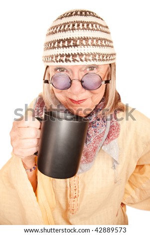 Crazy new age woman in a yellow robe smiling with coffee cup