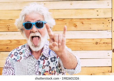 Crazy Nice Old Senior Man Expression Portrait With Colorful Clotehs - Concept Of Rebel No Limit Age And Youthful People - Caucasian Elderly Male With White Beard And Hair Do Rock'n Roll Sign