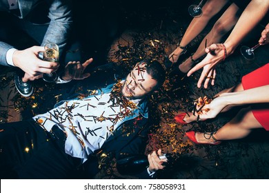 Crazy party. Drunk man lying on floor. New year, Birthday, Holiday Event concept