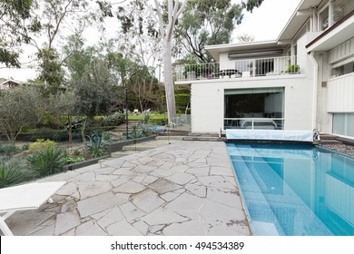 Crazy Paving Beside Swimming Pool In Mid Century Modern Australian Home