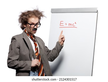 Crazy professor, scientist, lecturer with mad hairstyle wearing horn rimmed glasses and fake mustache standing in front of a whiteboard and pointing e=mc2