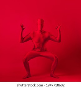 Crazy Red Man On A Red Background. Figure In A Leotard Covering The Whole Body