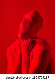 Crazy Red Man On A Red Background. Figure In A Leotard Covering The Whole Body