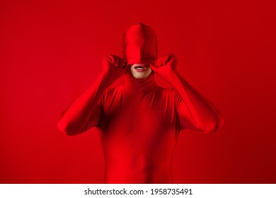 Crazy Red Man On A Red Background. Figure In A Leotard Covering The Whole Body