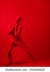 Crazy Red Man On A Red Background. Figure In A Leotard Covering The Whole Body