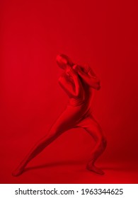 Crazy Red Man On A Red Background. Figure In A Leotard Covering The Whole Body