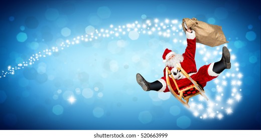 crazy santa claus on his sleigh hilarious fast funny crazy xmas christmas gift present delivery blue wide panorama bokeh background