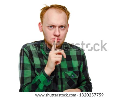 crazy, scared red haired man show gesture silence. angry caucasian male geek, nerd with hangover. depressed emotion. finger near lips of mouth. sign is warning, secret, shush. serious redhead guy