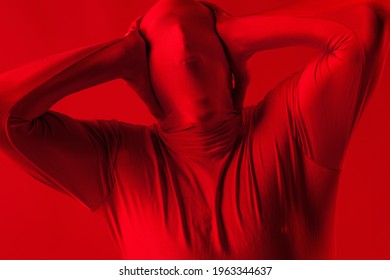 Crazy Screaming Red Man On A Red Background. Figure In A Leotard