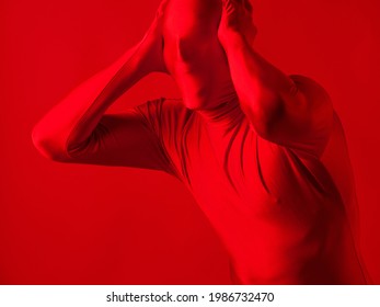 Crazy Screaming Red Man On A Red Background. Figure In A Leotard