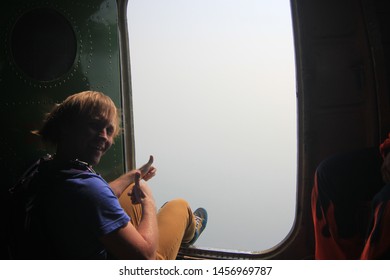 Crazy Smile. Skydiving And Open Door In Plane.Foot In Fast Wind.