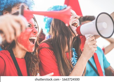 Crazy Sport Fans Screaming While Supporting Their Team - Football Supporters Having Fun Inside Stadium For Soccer Match - Event Concept - Focus On Right Man Face - Focus On Speaker