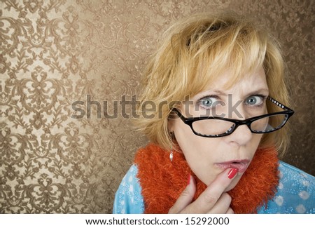 Crazy woman with glasses suspiciously eyeing the camera