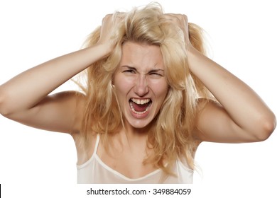 crazy woman pulling her messy hair 