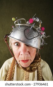 Crazy woman wearing a metal colander for a helmet