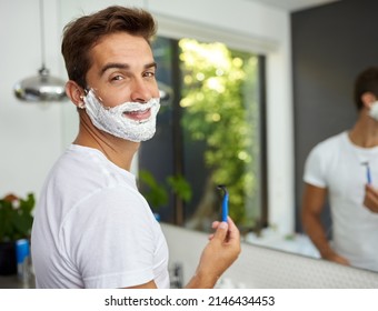 The cream before its all gone. Cropped shot of a handsome man about to shave his beard in the bathroom at home. - Powered by Shutterstock