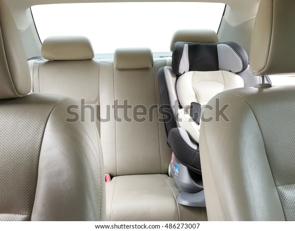 Cream beige leather\
Rear seats car with a car seat for child, family car interior\
isolated on white\
background