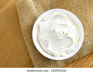 Cream Cheese, Quark Or Yogurt In A White Bowl. Dairy Product, Healthy Eating Theme. Wooden Table Background.