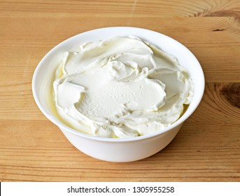 Cream Cheese, Quark Or Yogurt In A White Bowl. Dairy Product, Healthy Eating Theme. Wooden Table Background.