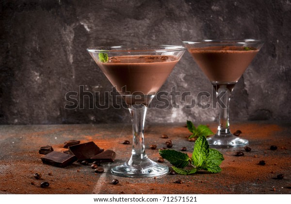 Cream coffee cocktail, chocolate martini with\
mint on black stone table, copy\
space