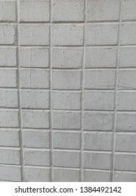 Cream Colored Brick Wall With Small Side Of Bricks Exposed