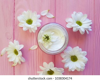 cream cosmetic white flowers on a pink wooden - Shutterstock ID 1038304174