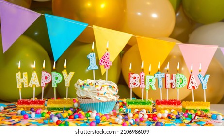 Cream cupcake with a candle for fourteen years, Greeting colorful card happy birthday to a child of 14 years old, birthday cupcake with candles and birthday decorations