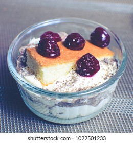 cream dessert in a bowl with cherries