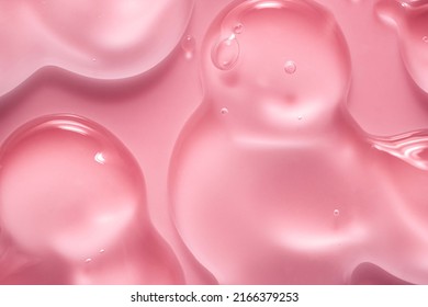 Cream gel drops red transparent cosmetic sample texture and bubbles pink background