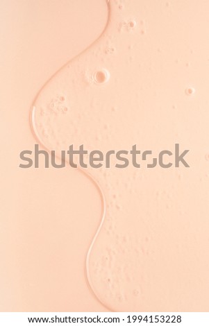 Cream gel pink beige transparent cosmetic serum oil sample texture with bubbles  background