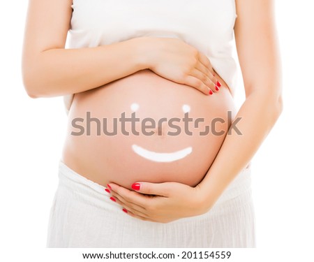 Cream happy smiley face on the belly of pregnant woman isolated on white