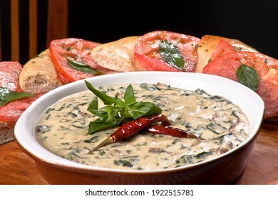 Cream Of Mushroom Soup With Corn Kernels, Poblano Slices, Dried Chili And Pieces Of Bread With Red Tomato