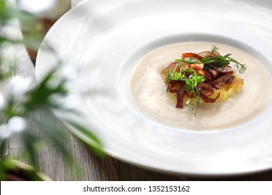 Cream Of Roasted Cauliflower Soup With Confit Of Onions.