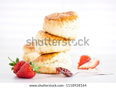 Cream Tea - scones with jam, cream and strawberrys on a white background