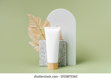 Cream Tube  Mockup With Leaf And Geometrical Forms On Green Background. Natural Skincare Beauty Product For Branding And Packaging Presentation. 