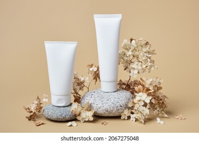 Cream Tubes Mockup For Branding Presentation. Natural Skincare Beauty Product On Rounded Pebble Podium. Natural Earthy Colors