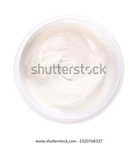 Cream yogurt, in a plastic cup. Stirred yoghurt, also spelled yogourt or yoghourt, with ten percent fat content. Dairy product, made by bacterial fermentation of mostly cow milk with yogurt cultures.