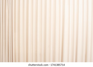 Cream-colored cloth, beige curtain fabric texture and background. 