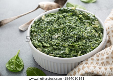 Creamed spinach with garlic in a white bowl