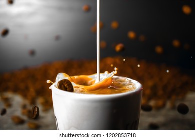 Creamer Mixing With Coffee While Coffee Beans Fall All Around 