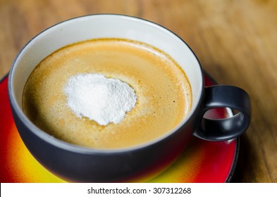 Creamer On A Cup Of Coffee On Wooden Background.