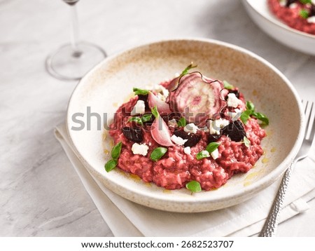 Creamy beetroot risotto with goat cheese and herbs