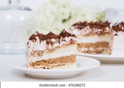 Creamy Cake On Plate On Table On Light Background