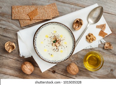 Creamy cauliflower soup in a bowl on a wooden table top view - Shutterstock ID 1015035328