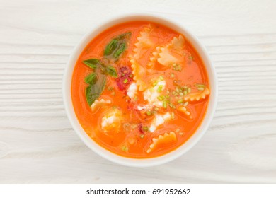 Creamy Cheese Tomato Lasagna Soup On White Rustic Background, Top View, Overhead, Copy Space